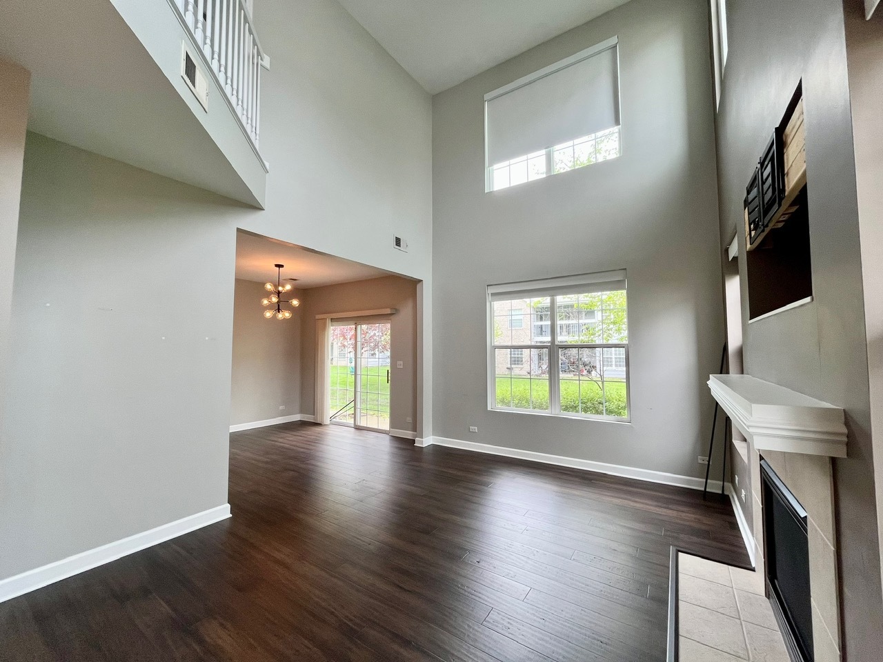 1919 Golden Gate Lane Naperville, IL 60563 - Photo 4 of 18 wooden floor in an empty room with a window