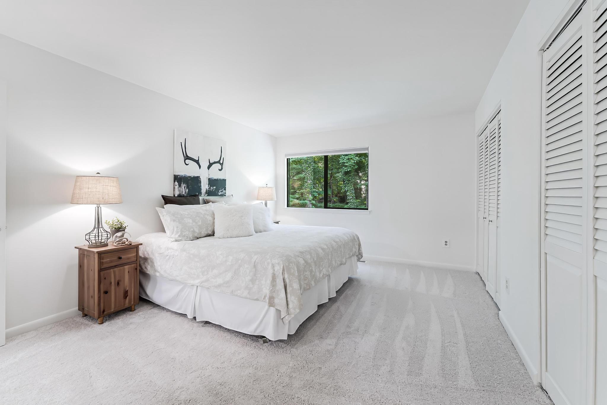 12023 Insha Court Reston, VA 20191 - Photo 46 of 52 a spacious bedroom with a bed and a window