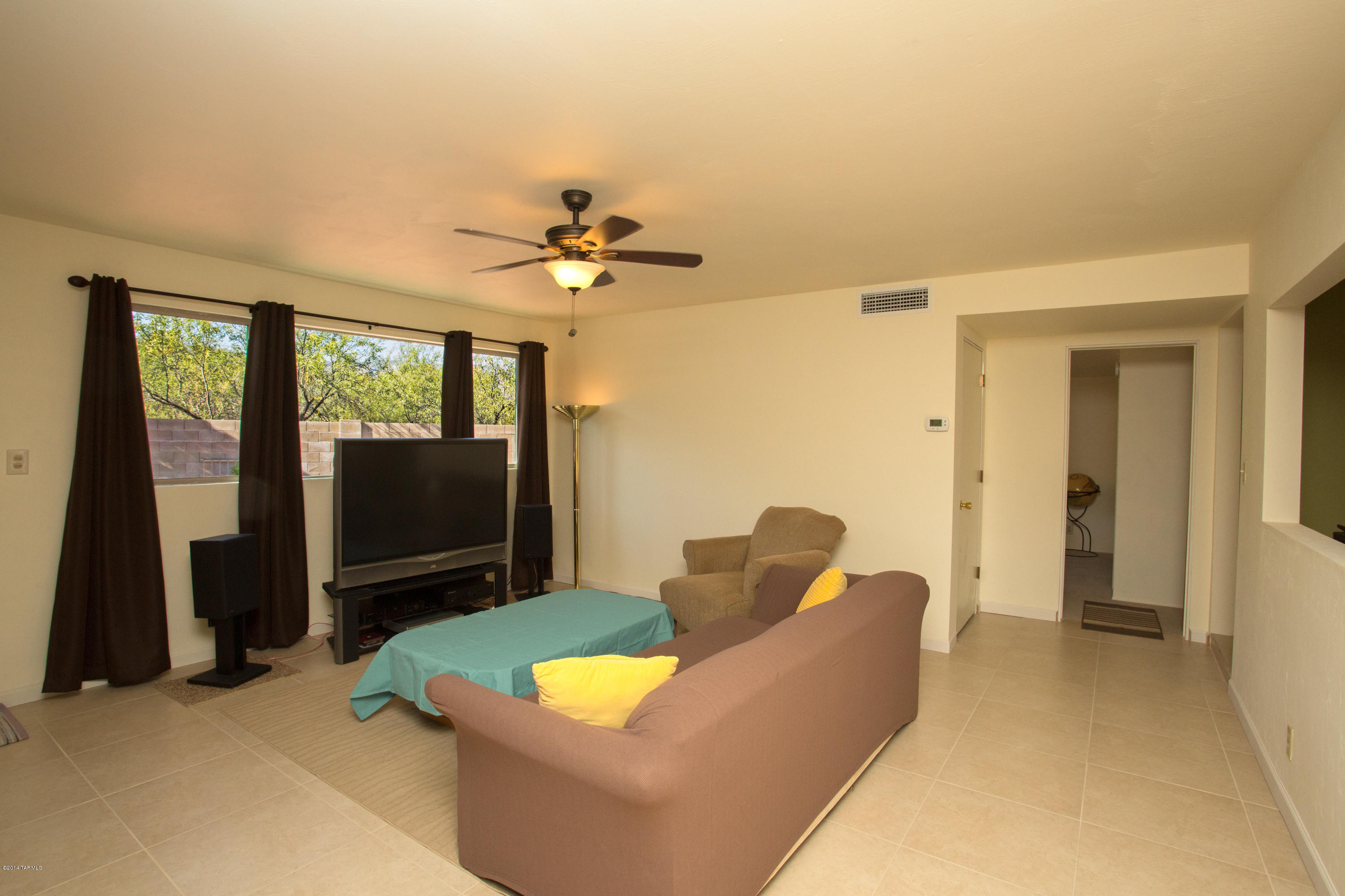 3240 North Webster Road Tucson, AZ 85750 - Photo 20 of 26 a living room with furniture and a flat screen tv
