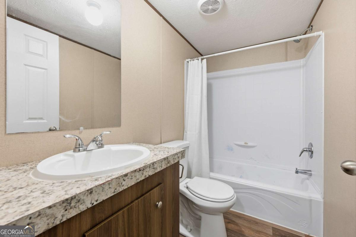 2232 Grandview Road Jasper, GA 30143 - Photo 15 of 29 a bathroom with a granite countertop sink toilet and shower