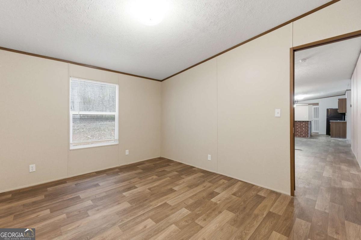 2232 Grandview Road Jasper, GA 30143 - Photo 18 of 29 a view of an empty room with wooden floor and a window
