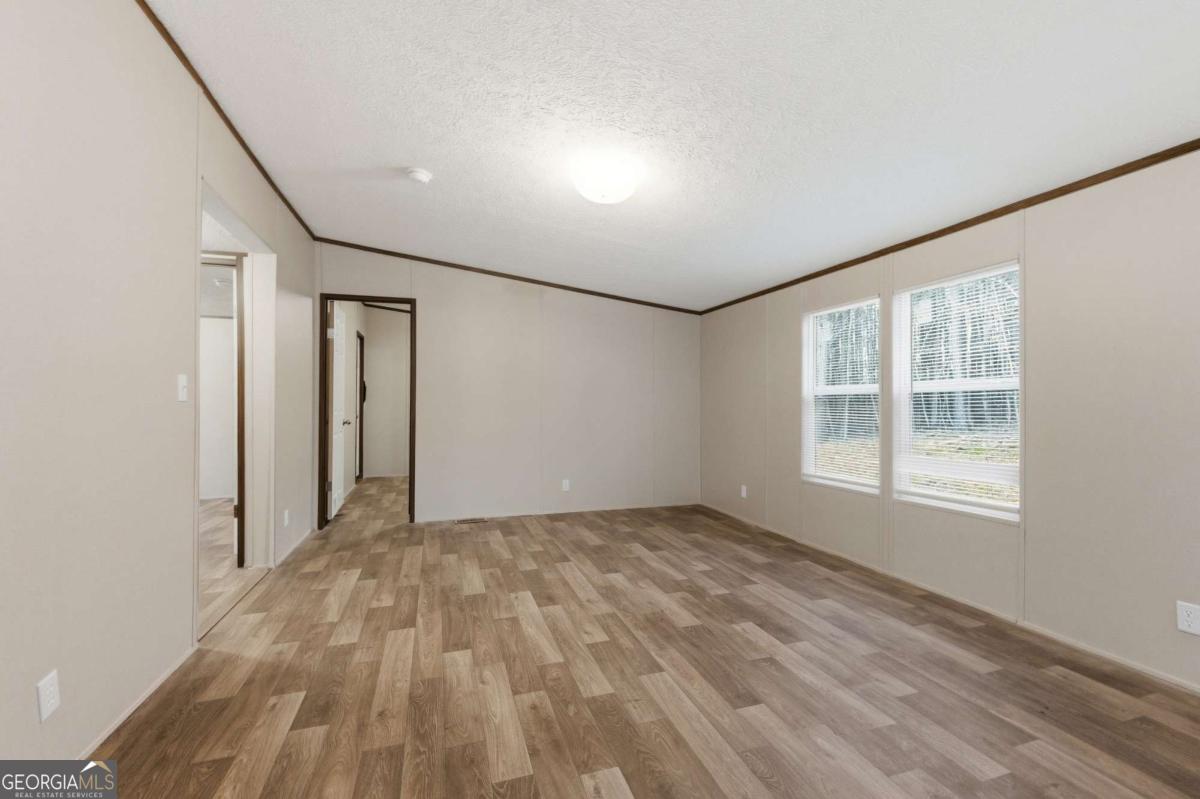 2232 Grandview Road Jasper, GA 30143 - Photo 19 of 29 a view of empty room with wooden floor and fan
