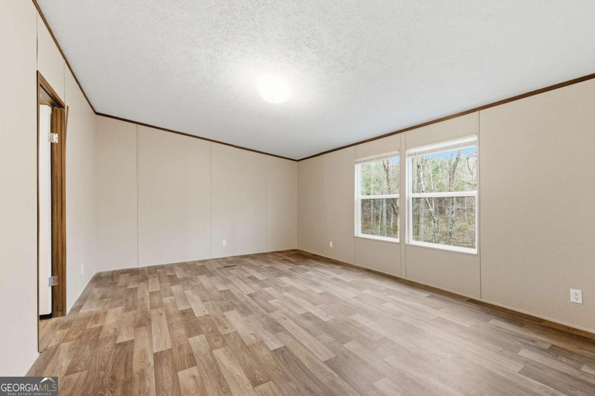 2232 Grandview Road Jasper, GA 30143 - Photo 21 of 29 an empty room with wooden floor and windows