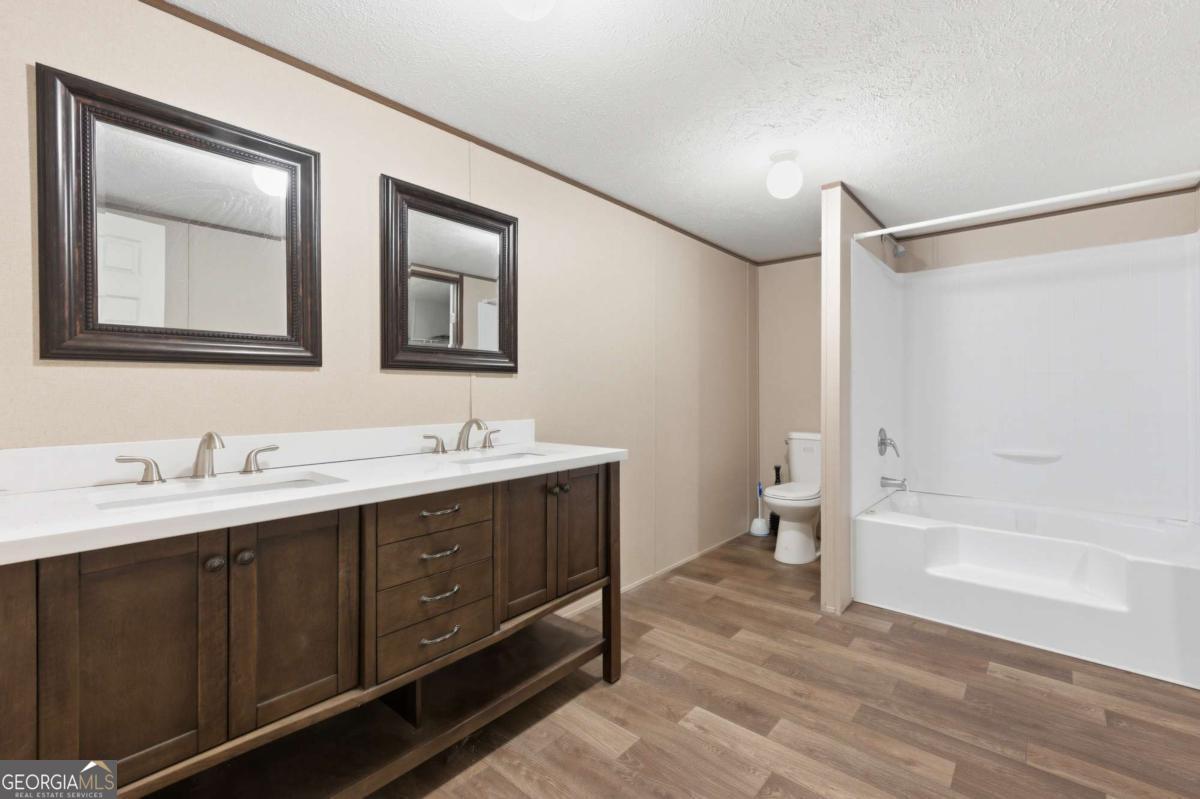 2232 Grandview Road Jasper, GA 30143 - Photo 22 of 29 a bathroom with a double vanity sink and a mirror