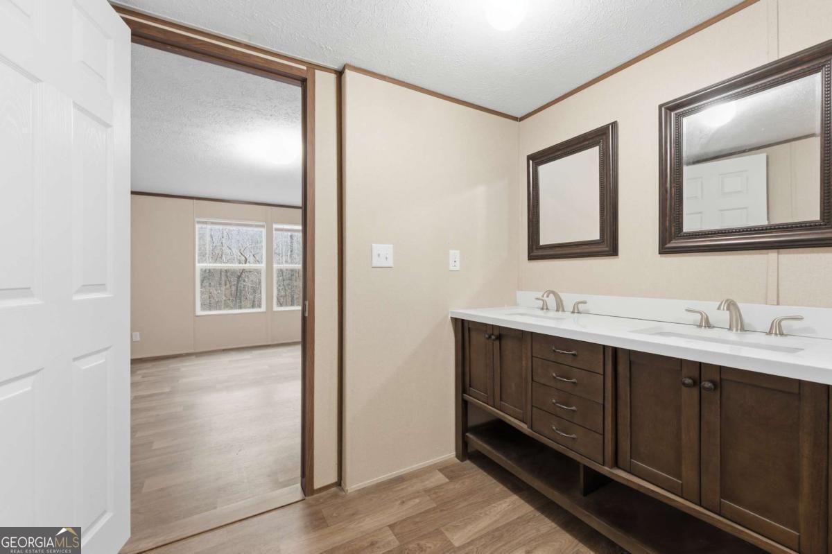 2232 Grandview Road Jasper, GA 30143 - Photo 23 of 29 a bathroom with double vanity sink and mirror