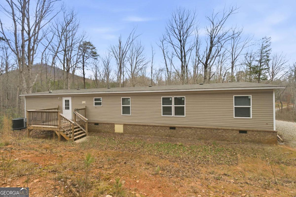 2232 Grandview Road Jasper, GA 30143 - Photo 28 of 29 a backyard of a house with large trees and fence