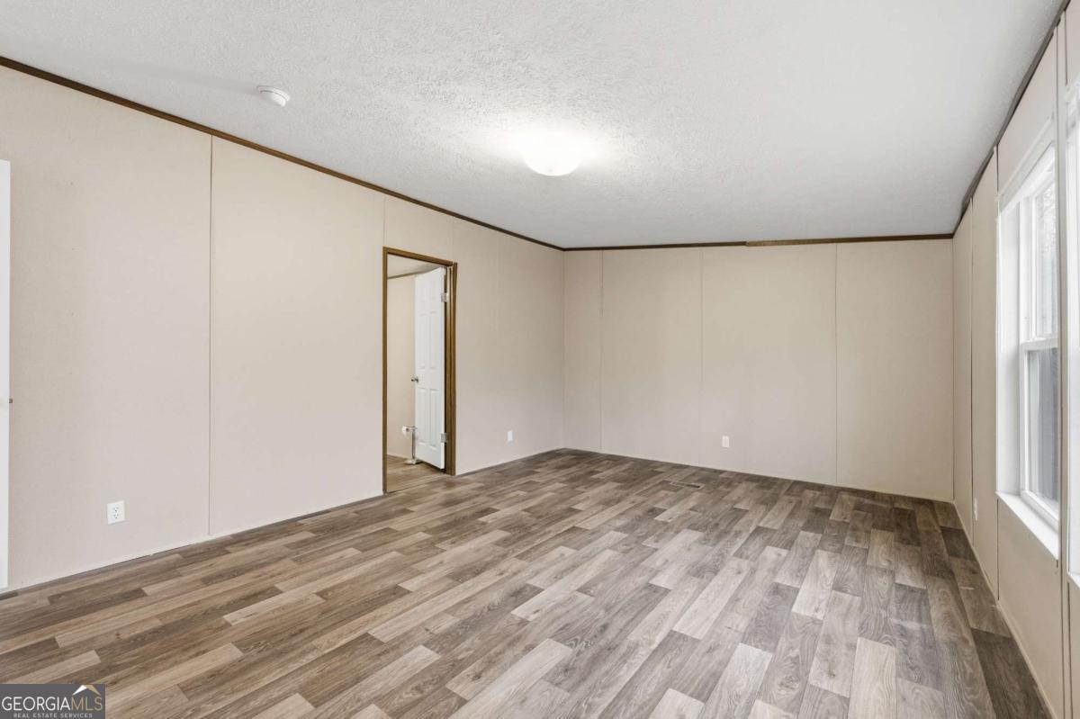 2232 Grandview Road Jasper, GA 30143 - Photo 5 of 29 a view of empty room with wooden floor and fan