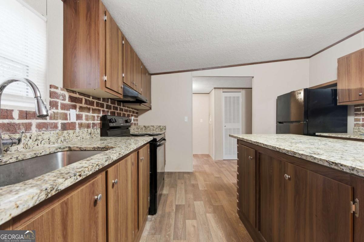 2232 Grandview Road Jasper, GA 30143 - Photo 7 of 29 a kitchen with granite countertop a sink and a stove