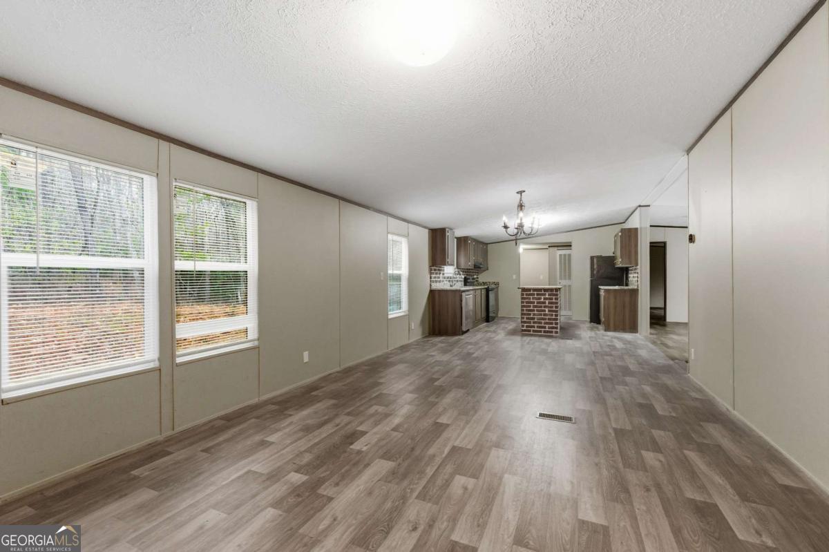 2232 Grandview Road Jasper, GA 30143 - Photo 9 of 29 a view of empty room with wooden floor and windows