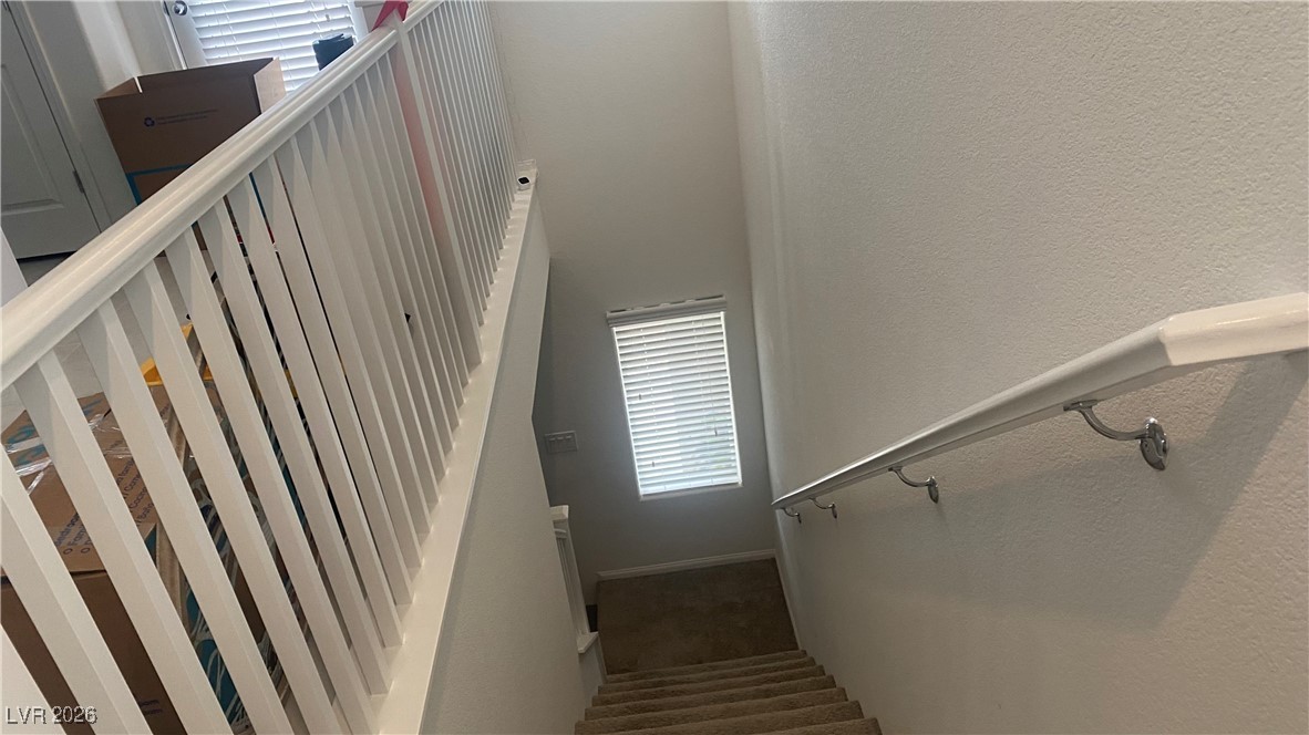5675 Spellbinding Street Las Vegas, NV 89148 - Photo 10 of 18 Stairs with a textured wall and carpet floors