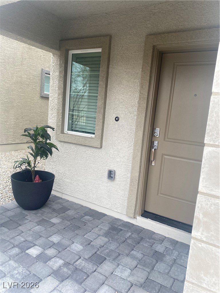 5675 Spellbinding Street Las Vegas, NV 89148 - Photo 14 of 18 Doorway to property with stucco siding
