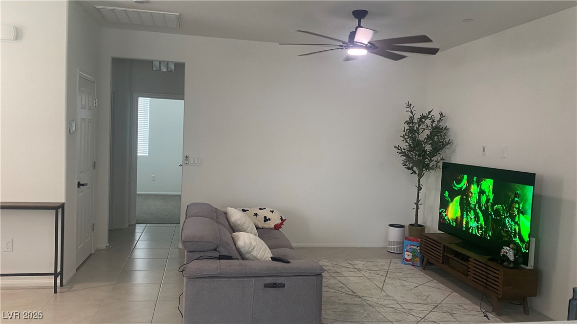 5675 Spellbinding Street Las Vegas, NV 89148 - Photo 8 of 18 Living room with ceiling fan and light tile patterned floors