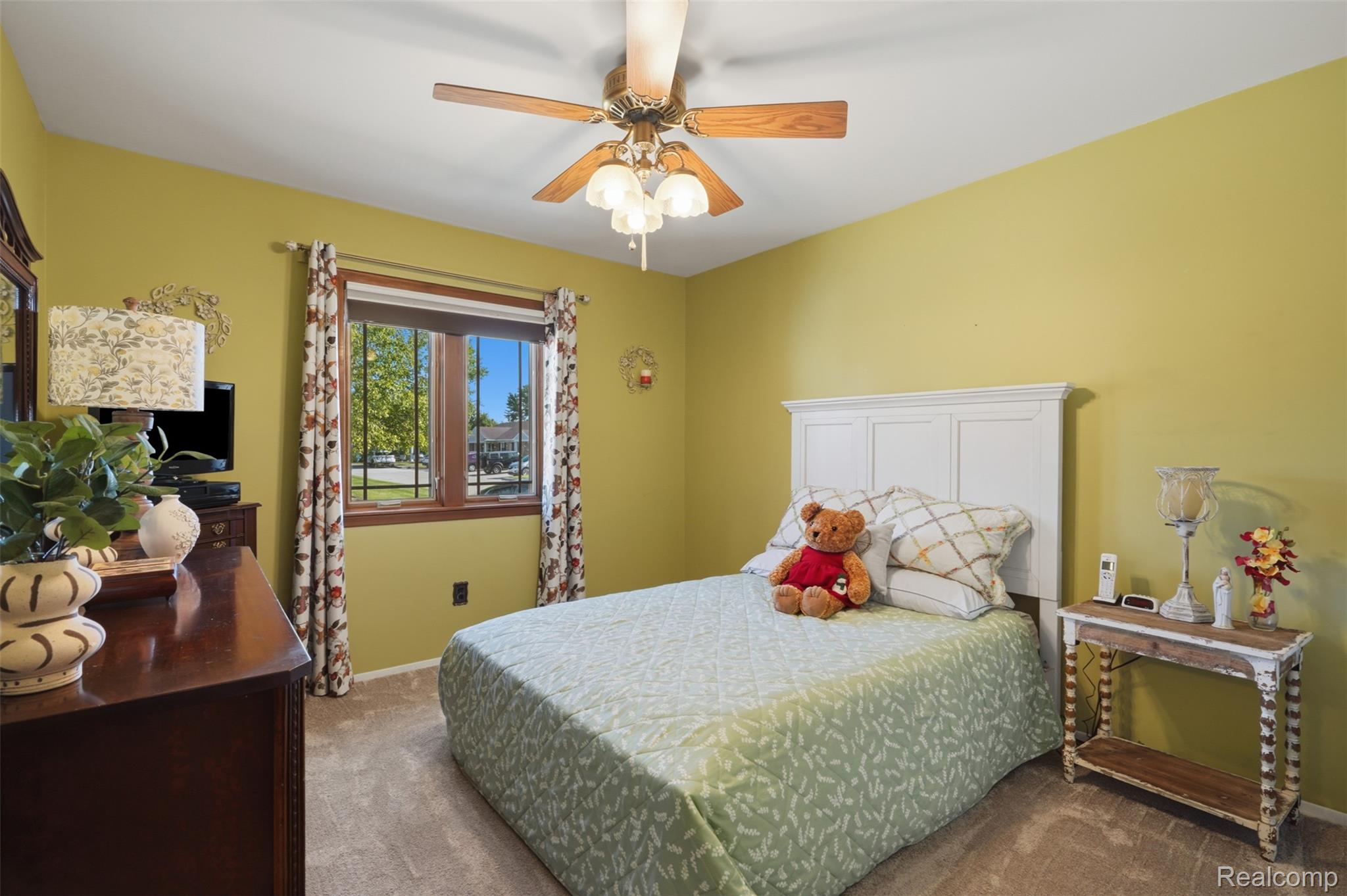 18160 Raleigh Square Drive Southgate, MI 48195 - Photo 19 of 31 Bedroom featuring a large window with wooden trim, neutral carpet, and a ceiling fan with light fixture