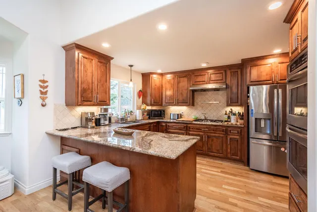a living room with furniture a fireplace and a window
