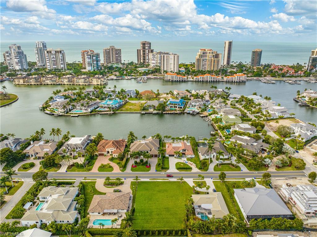 4228 Crayton Road Naples, FL 34103 - Photo 5 of 13 an aerial view of a city with lots of residential buildings ocean and boats