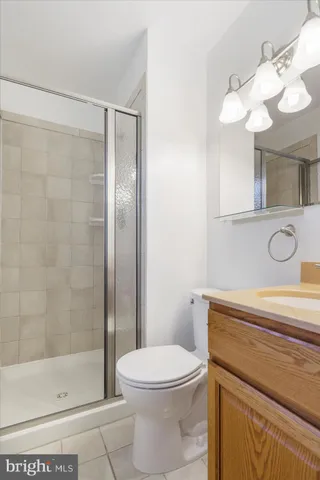 a bathroom with a toilet a sink and shower