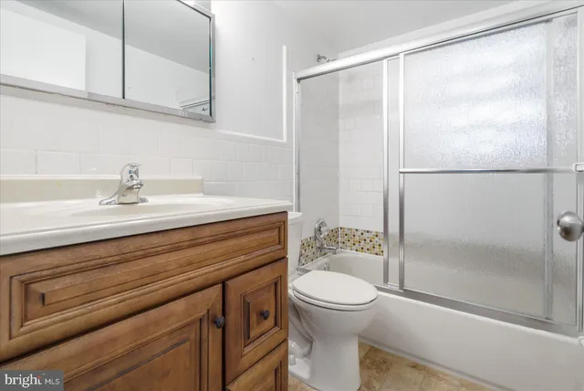 a bathroom with a sink a toilet and a shower