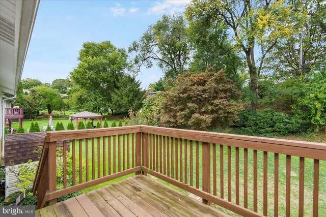 a view of balcony with wooden floor and fence