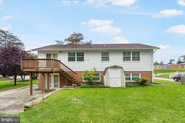 a view of a house with a backyard and a patio
