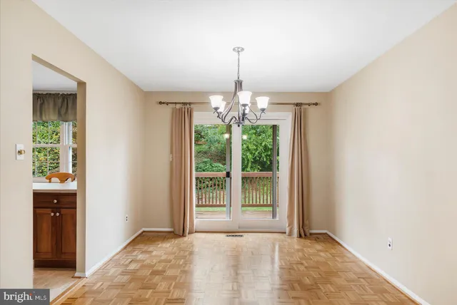 a view of an empty room with window and cabinet