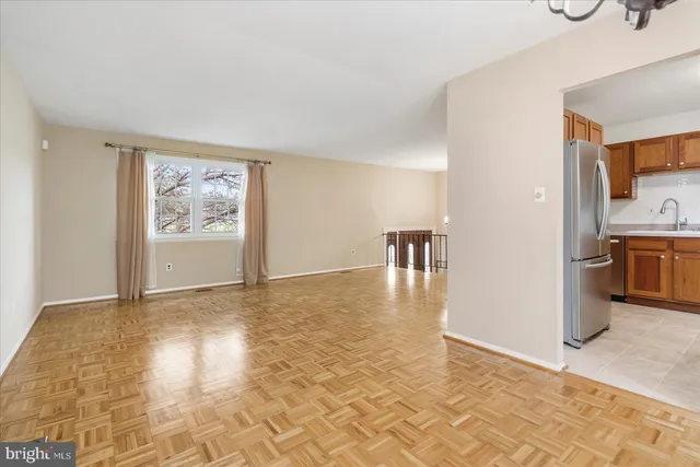 a view of a kitchen with furniture and wooden floor
