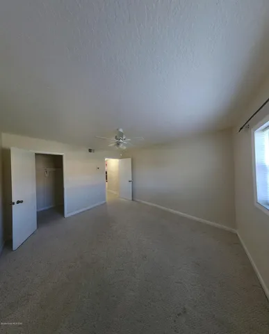 a view of empty room with windows and fireplace