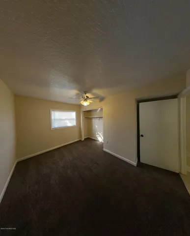 a view of empty room and a window
