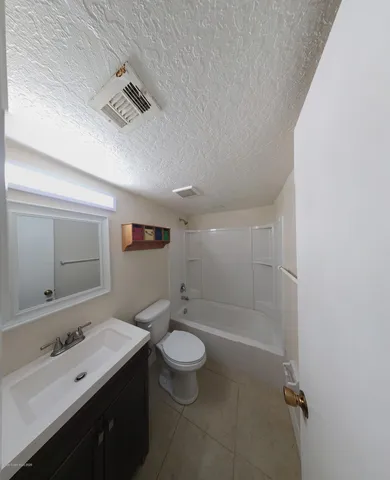 a bathroom with a double vanity sink toilet mirror and shower