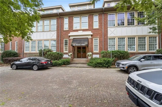 a view of a house with a yard and tree s