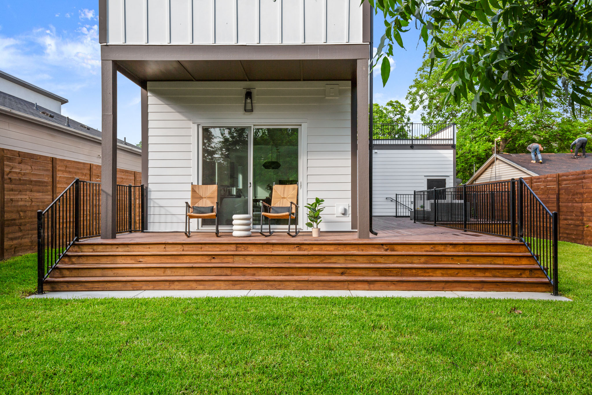 1912 Madison Avenue Austin, TX 78757 - Photo 16 of 17 Back of house with board and batten siding, a deck, and a fenced backyard