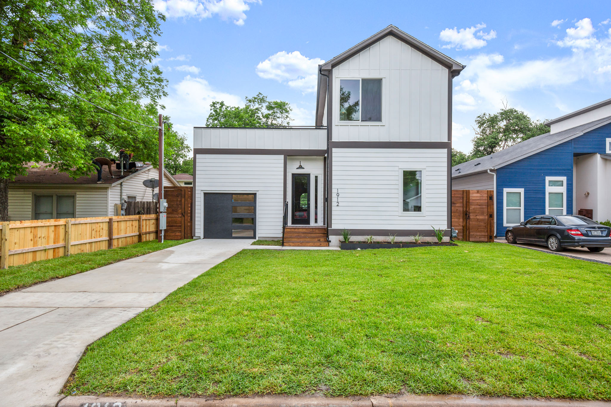 1912 Madison Avenue Austin, TX 78757 - Photo 17 of 17 Contemporary home with driveway, board and batten siding, and a garage