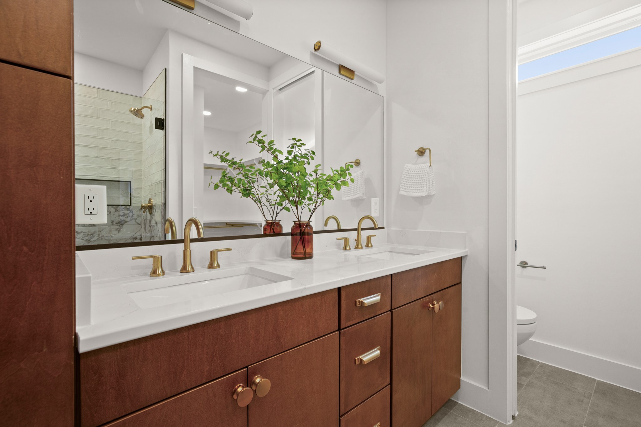 1912 Madison Avenue Austin, TX 78757 - Photo 7 of 17 Full bathroom featuring double vanity, a tile shower, and light tile patterned floors