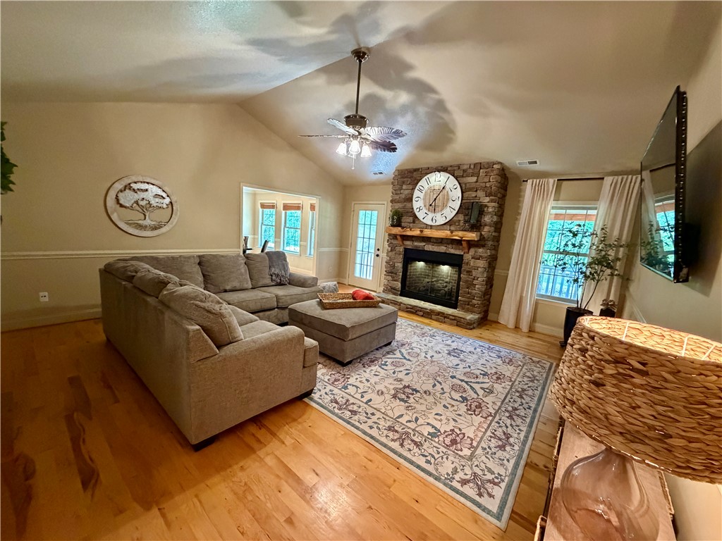 232 Hunters Trail Walhalla, SC 29691 - Photo 7 of 38 This living room features rich wood flooring, a striking stone fireplace, and a vaulted ceiling.