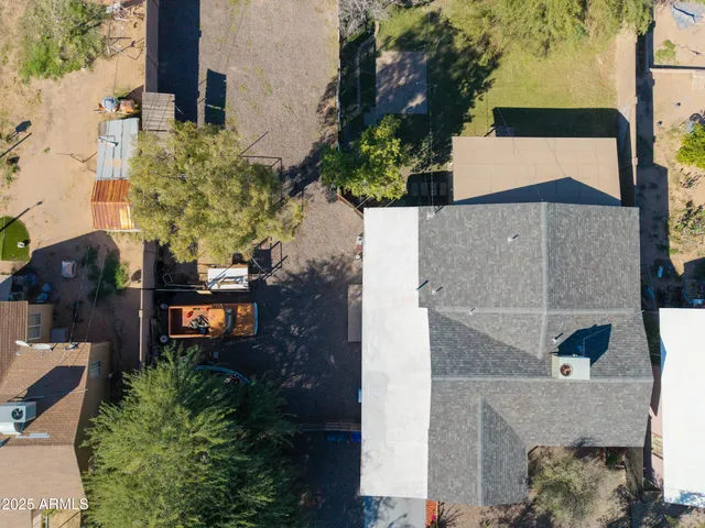 an aerial view of a house with a yard and potted plants