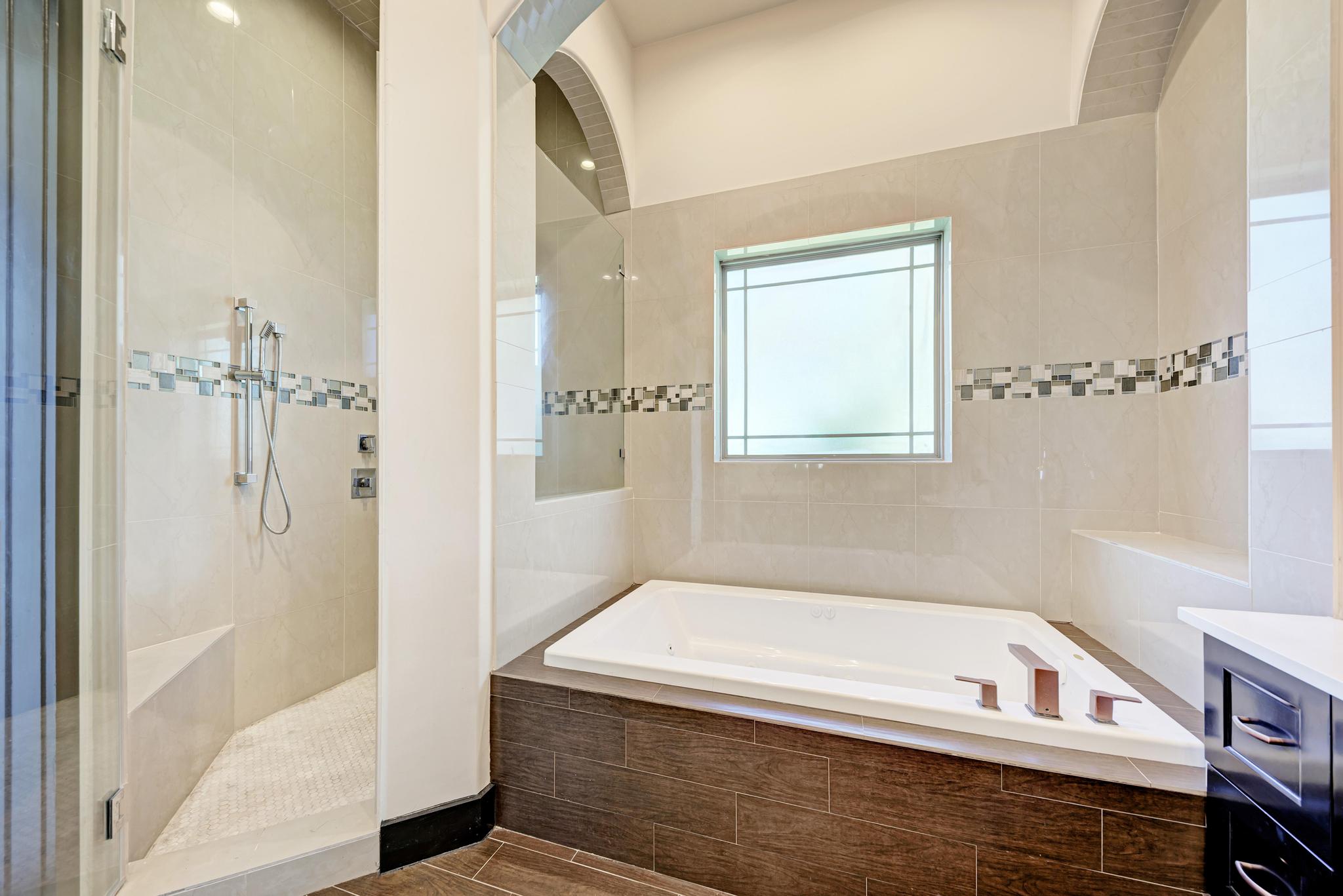 104 Spring Valley Street Hutto, TX 78634 - Photo 18 of 40 Bathroom featuring a bath, a shower stall, and vanity