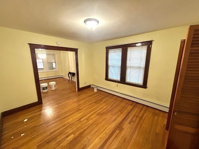 119 Bailey Road, Unit 1 Somerville, MA 02145 - Photo 16 of 25 wooden floor in an empty room with a window