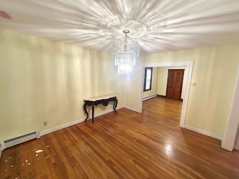 119 Bailey Road, Unit 1 Somerville, MA 02145 - Photo 4 of 25 a view of a livingroom with wooden floor and a ceiling fan