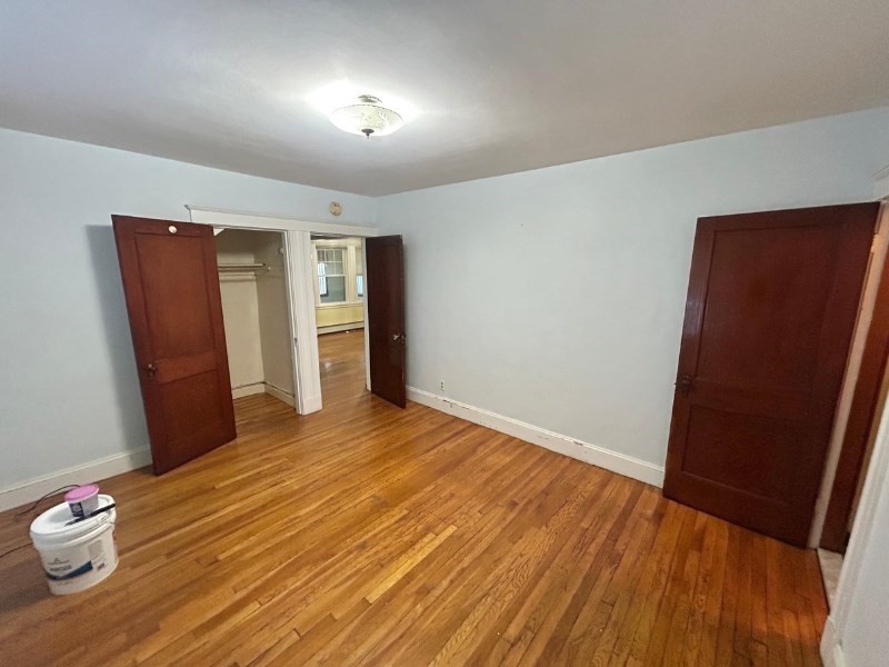 119 Bailey Road, Unit 1 Somerville, MA 02145 - Photo 8 of 25 a view of empty room with wooden floor