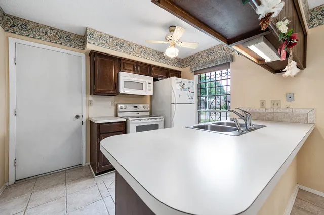 a kitchen with a sink a stove and cabinets