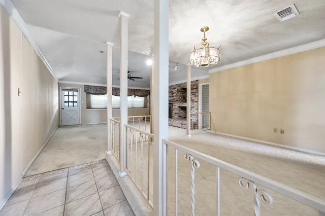 a view of a hallway with chandelier