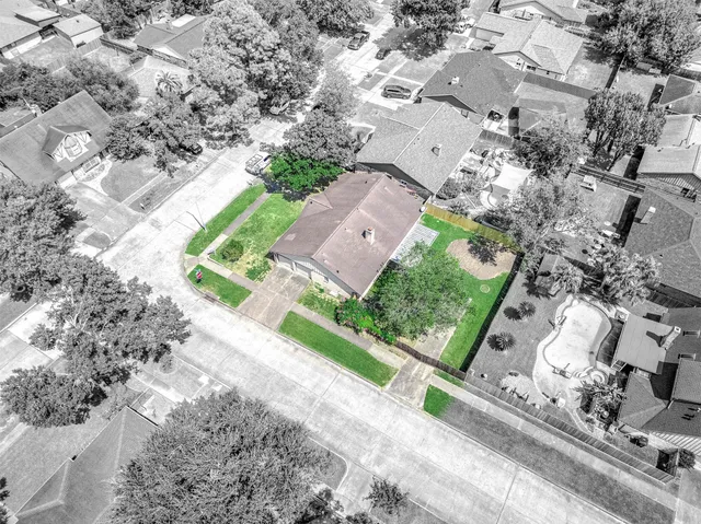 an aerial view of residential houses with outdoor space