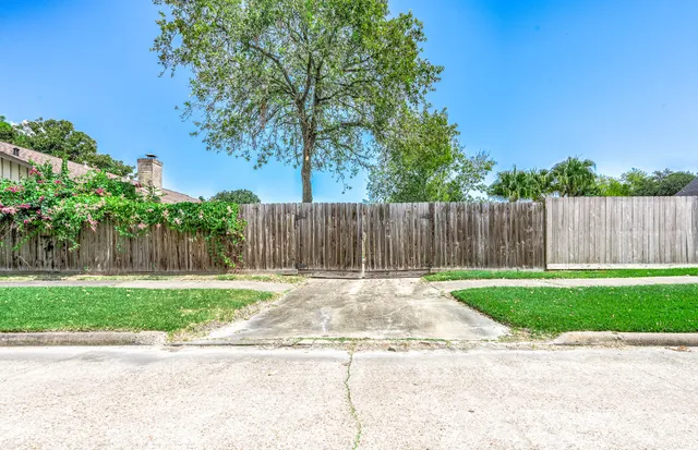 a backyard of a house with wooden fence
