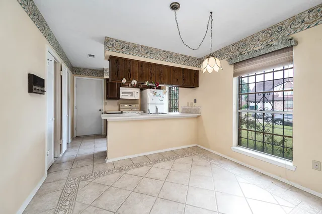 a view of a kitchen with a sink and cabinets