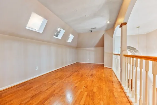 a view of empty room with wooden floor