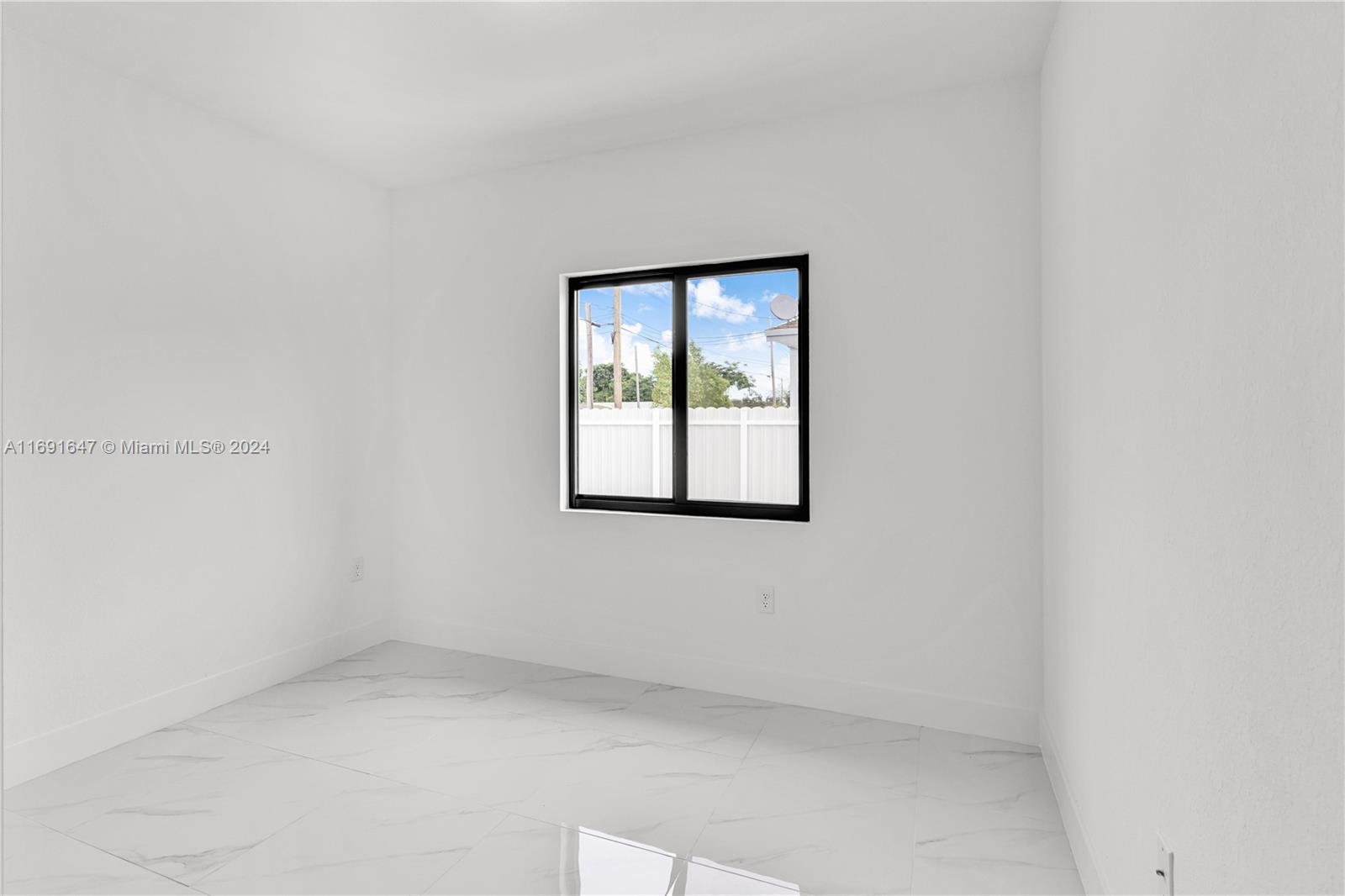11970 Southwest 213th Street, Unit 1 Miami, FL 33177 - Photo 12 of 36 an empty room with a window