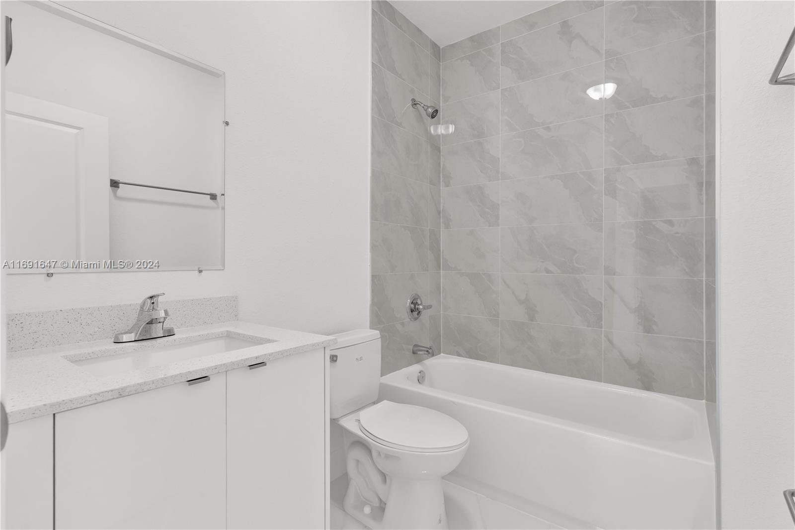 11970 Southwest 213th Street, Unit 1 Miami, FL 33177 - Photo 14 of 36 a bathroom with a sink a toilet and shower