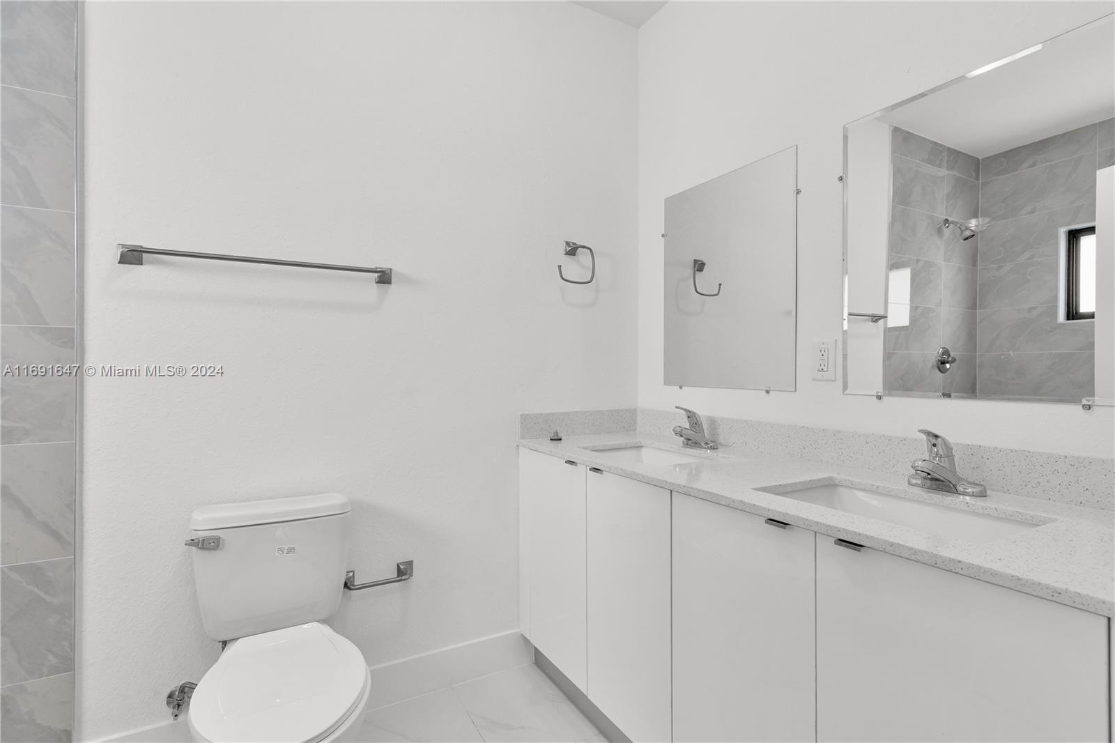 11970 Southwest 213th Street, Unit 1 Miami, FL 33177 - Photo 19 of 36 a bathroom with a granite countertop sink mirror and toilet