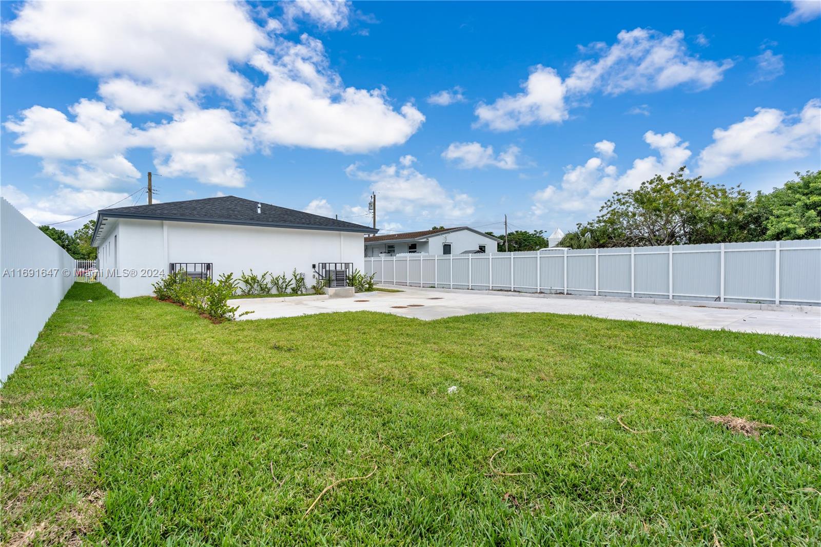 11970 Southwest 213th Street, Unit 1 Miami, FL 33177 - Photo 24 of 36 a view of a back yard