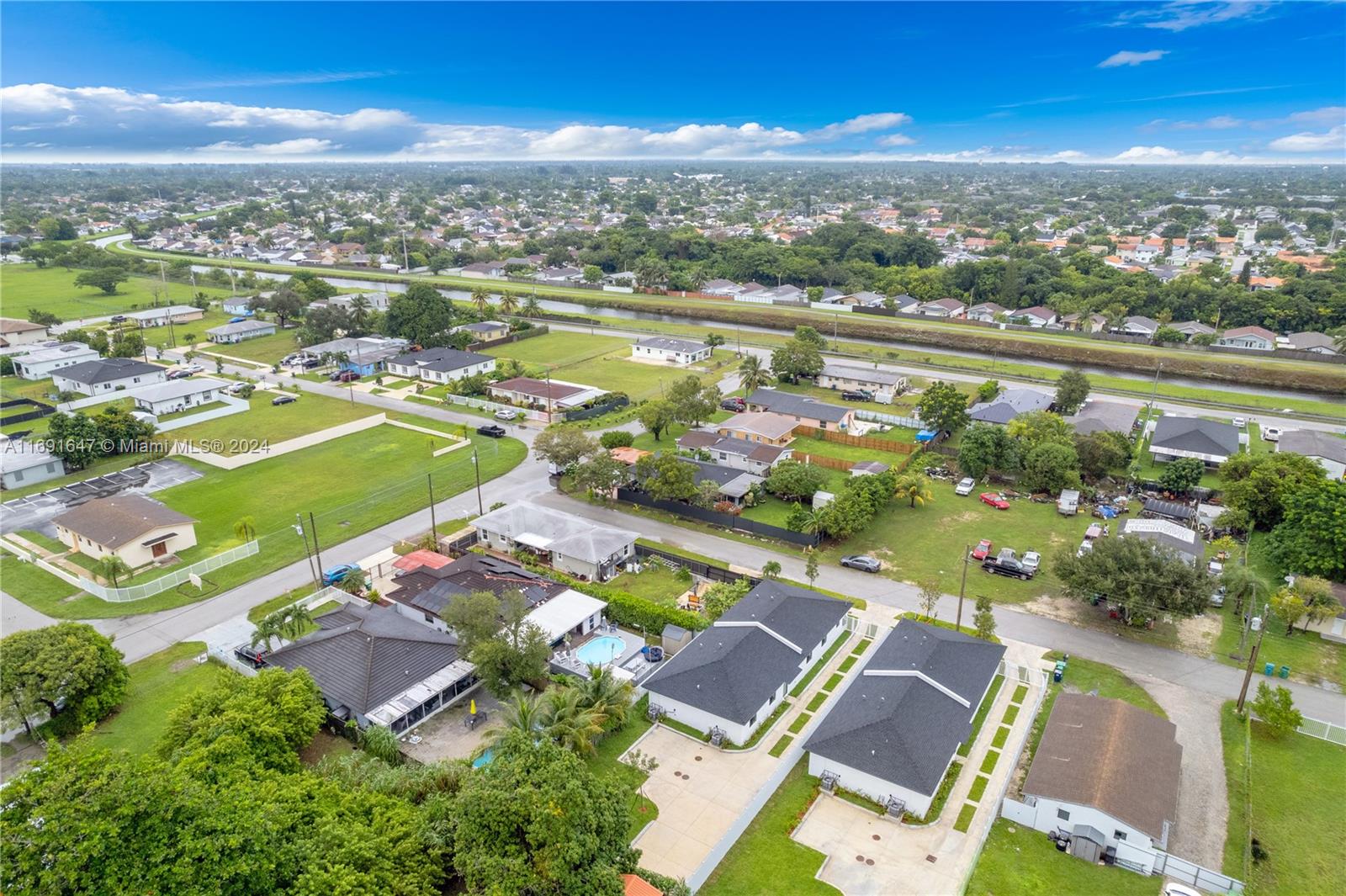 11970 Southwest 213th Street, Unit 1 Miami, FL 33177 - Photo 32 of 36 an aerial view of residential houses with outdoor space