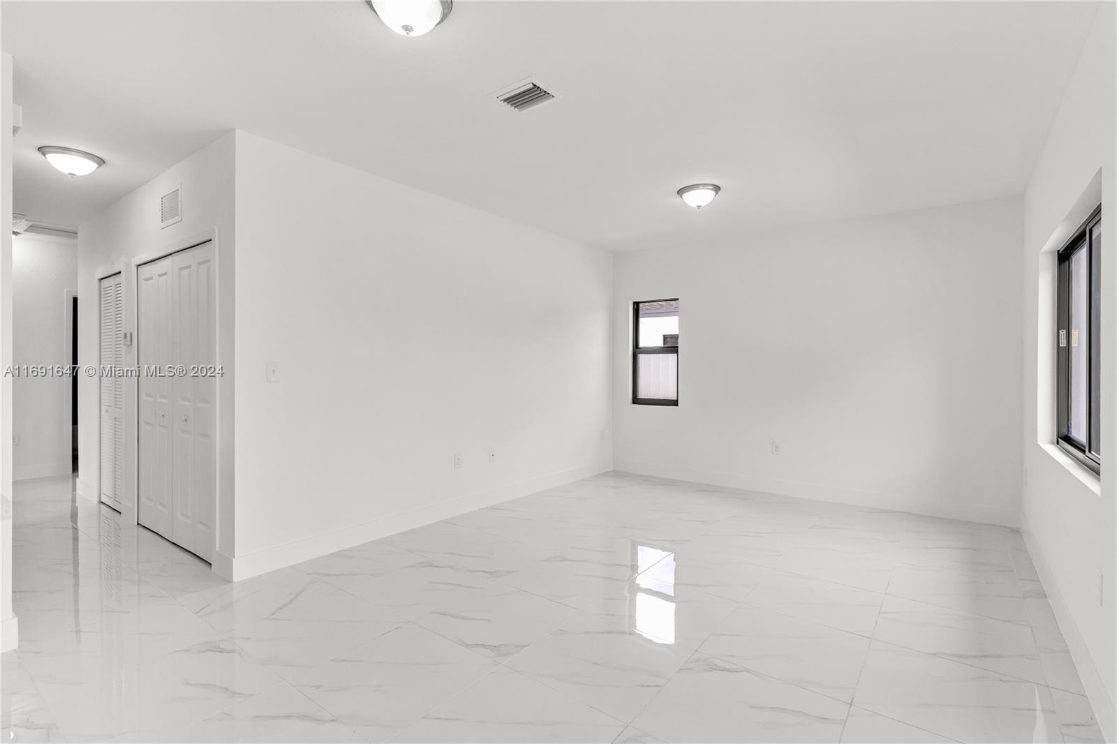 11970 Southwest 213th Street, Unit 1 Miami, FL 33177 - Photo 5 of 36 a view of empty room with windows